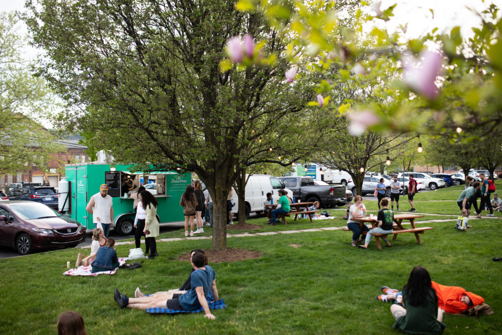 Community members lounging on the climbing gym lawn